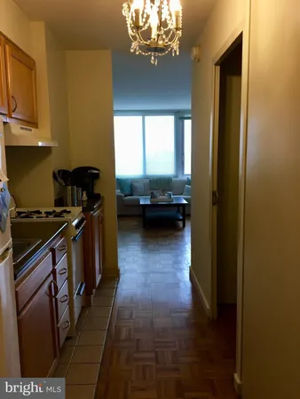 a kitchen with a refrigerator and a stove