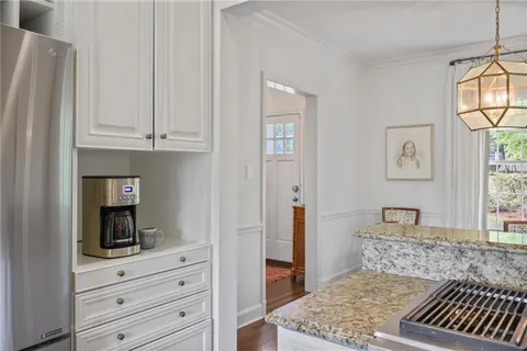 a kitchen with stainless steel appliances granite countertop a stove and a refrigerator