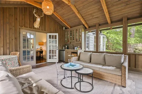 a view of a porch with furniture and wooden floor
