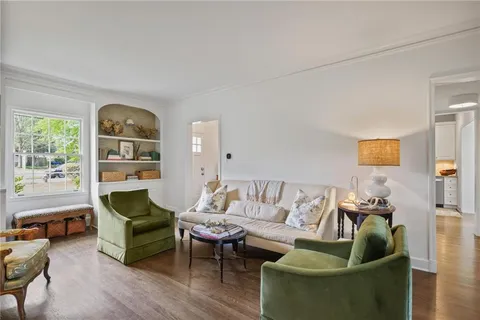 a living room with furniture and a book shelf