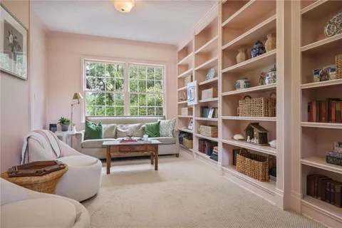 a dining room with furniture a window and wooden floor
