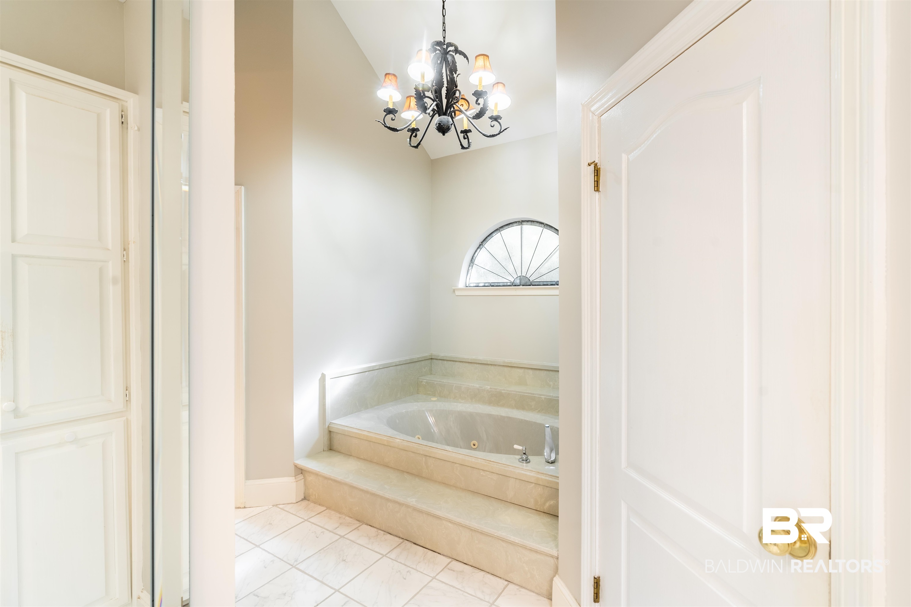 3821 St Andrews Loop East Mobile, AL 36693 - Photo 29 of 41 Bathroom with a relaxing tiled tub, a notable chandelier, and tile patterned floors