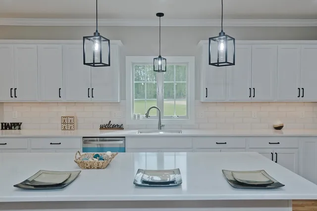 a kitchen with a sink a stove and cabinets