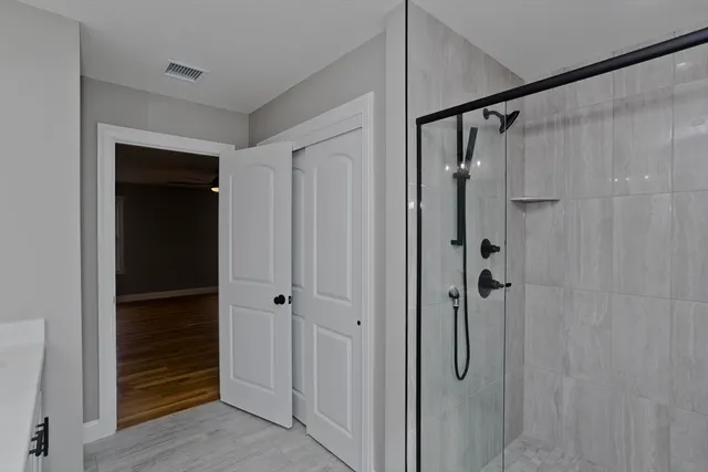 a bathroom with a glass door shower