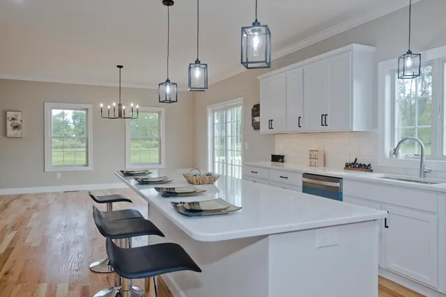 a kitchen with furniture a window and appliances
