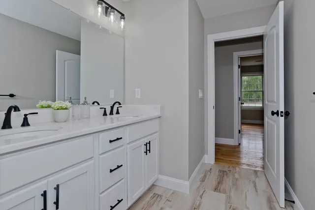 a en suite bathroom with a sink double vanity and a mirror