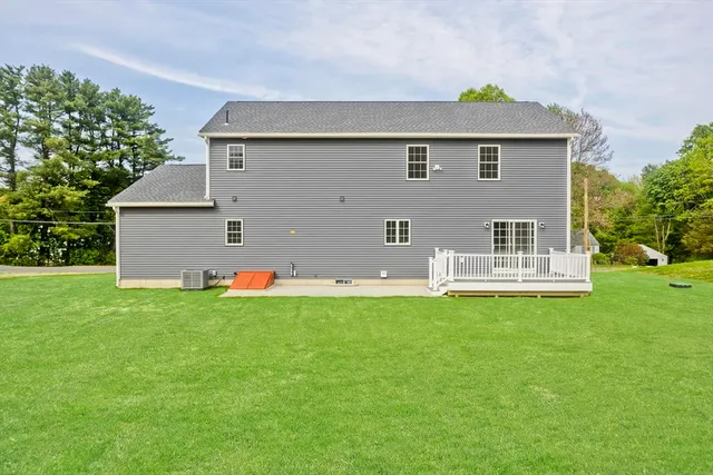 a view of a house with a small porch and wooden fence