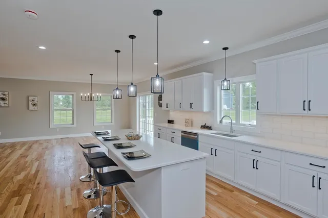 a kitchen with a table chairs stove and wooden floor