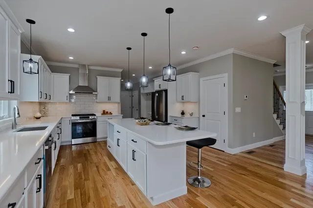 a large kitchen with stainless steel appliances kitchen island granite countertop a stove a sink a refrigerator and a wooden cabinets