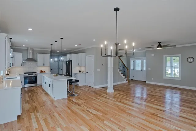 a view of a living room and kitchen with stainless steel appliances
