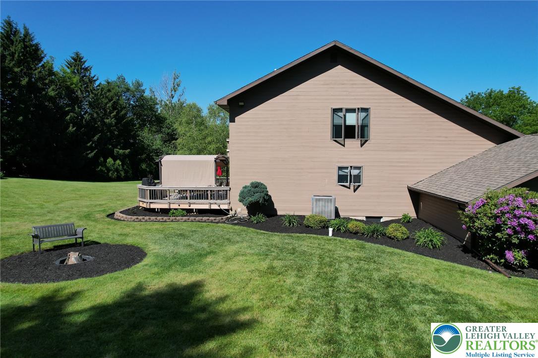 3470 Brodhead Road Bethlehem, PA 18020 - Photo 23 of 84 A neatly manicured lawn embraces the side of this home, featuring a charming fire pit and a private deck.