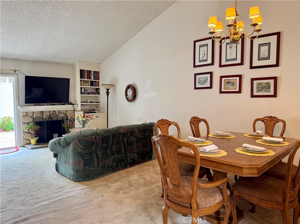 8 Coldstream Irvine, CA 92604 - Photo 5 of 27 a living room with furniture a flat screen tv and a fireplace