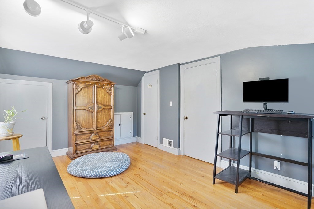 49 Marchioness Road Springfield, MA 01129 - Photo 18 of 35 a living room with furniture a dining table and a flat screen tv with wooden floor
