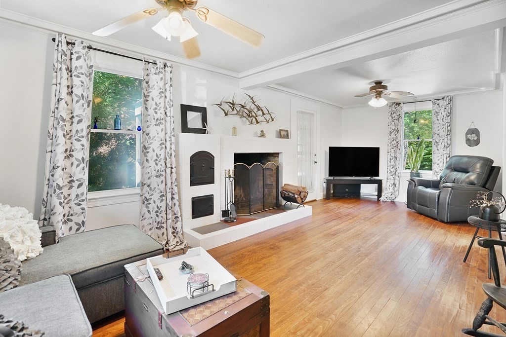 49 Marchioness Road Springfield, MA 01129 - Photo 4 of 35 a living room with furniture a fireplace and a flat screen tv