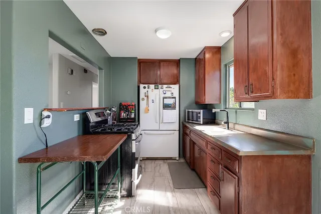 a kitchen with stainless steel appliances granite countertop a stove and a refrigerator