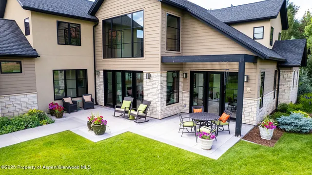 a bedroom with a bed and a large window with outer view