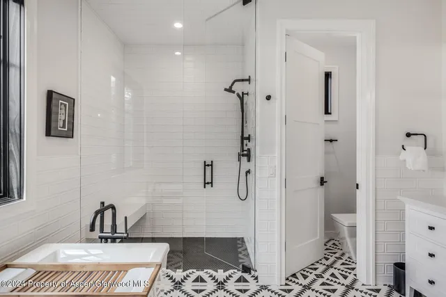 a view of a grassy field with trees in the background