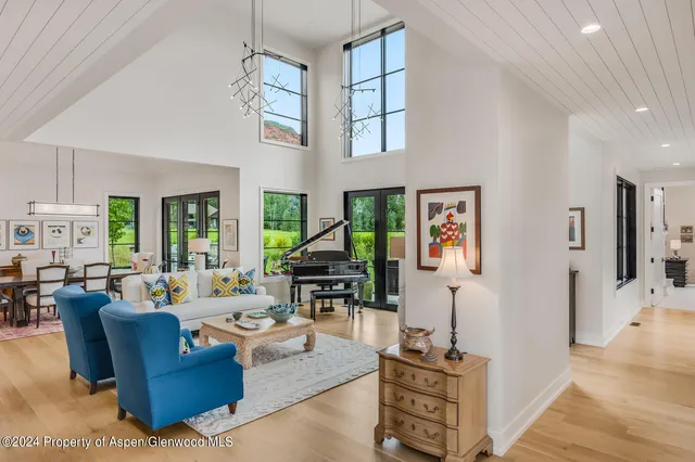 a kitchen with stainless steel appliances granite countertop a stove a kitchen island a dining table and chairs