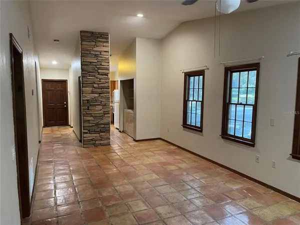 a view of a livingroom with a fireplace and a chandelier