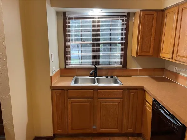 a kitchen with granite countertop a stove and a microwave