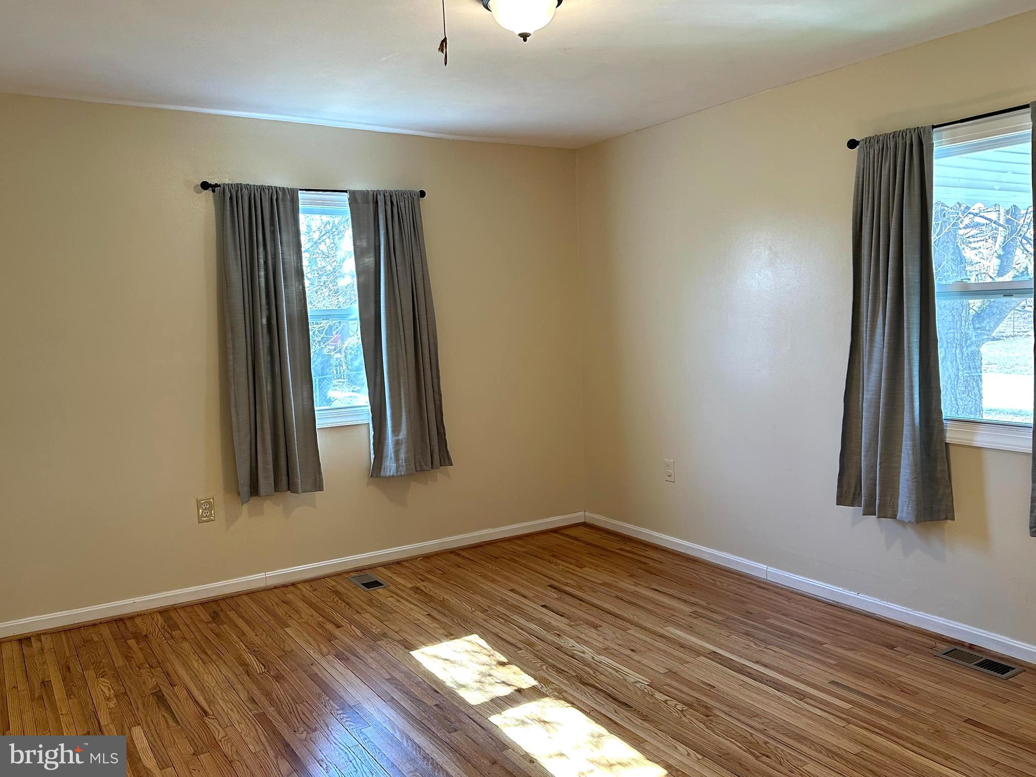 814 North Reymann Street Ranson, WV 25438 - Photo 11 of 19 wooden floor in an empty room with a window