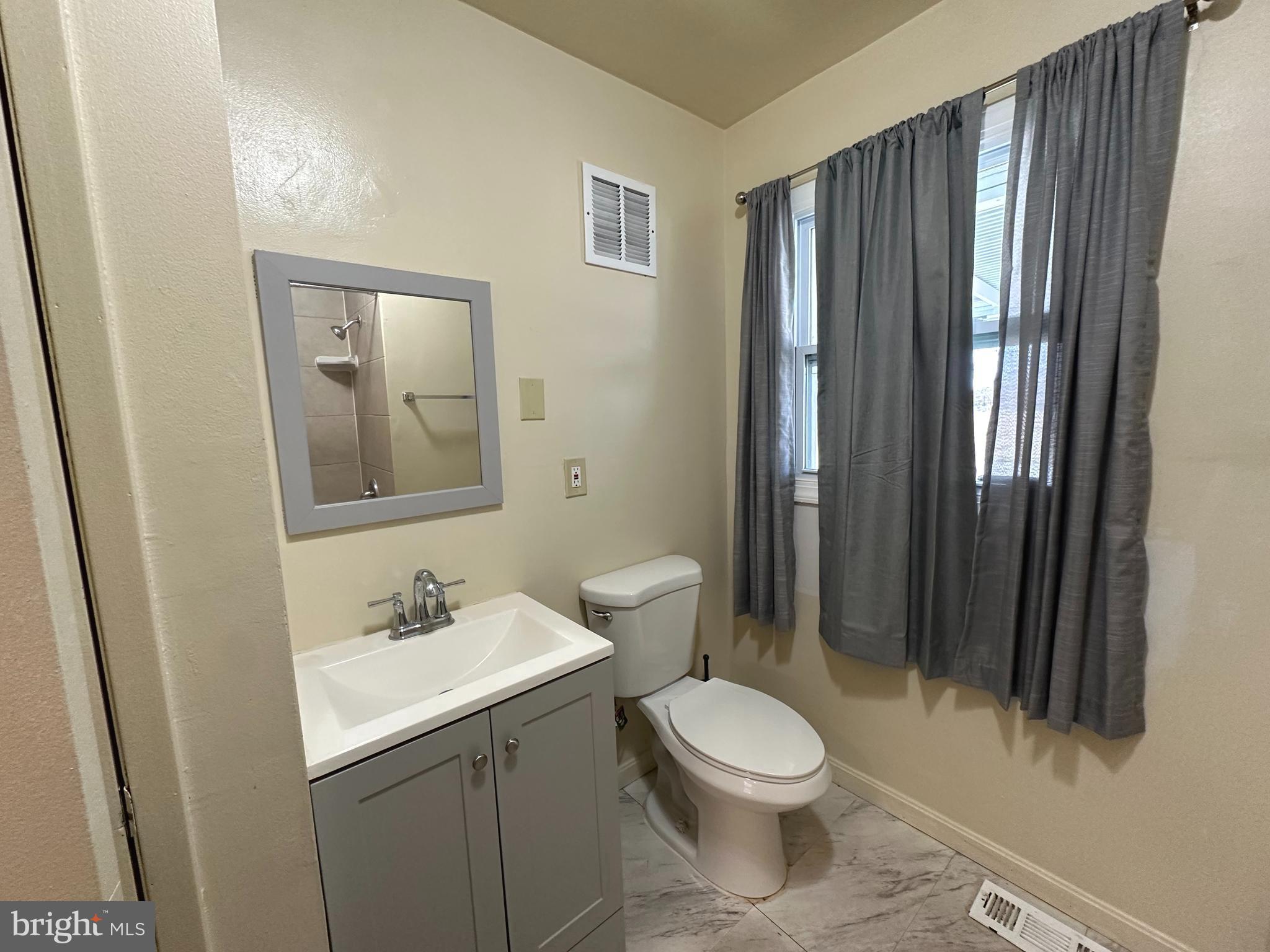 814 North Reymann Street Ranson, WV 25438 - Photo 13 of 19 a bathroom with a toilet a sink and mirror