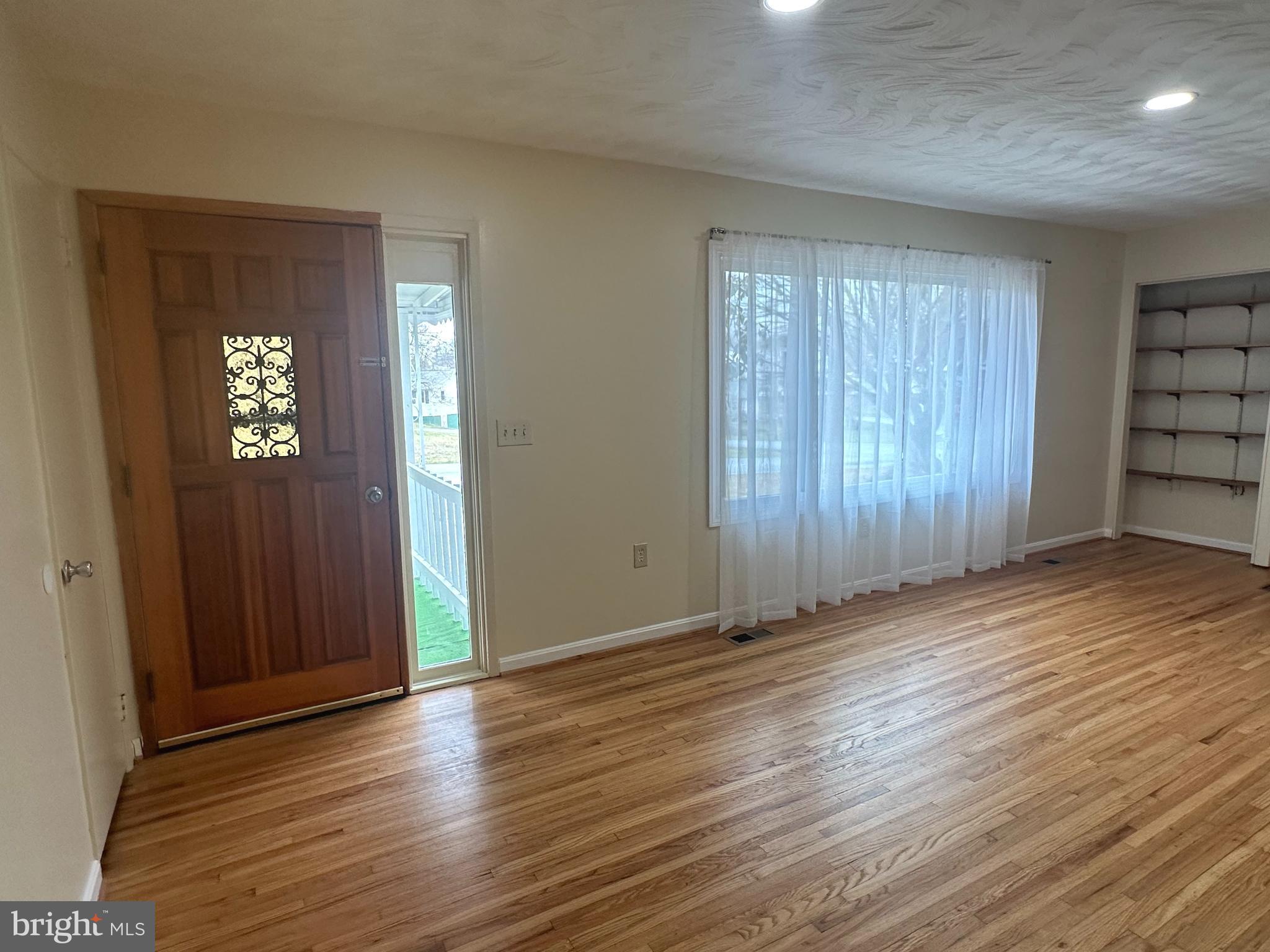 814 North Reymann Street Ranson, WV 25438 - Photo 8 of 19 an empty room with wooden floor and windows