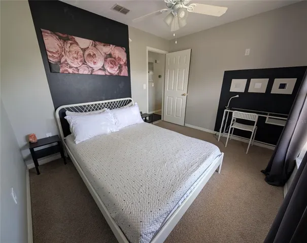 a bed sitting in a bedroom and chair