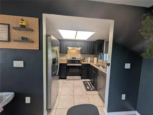 a kitchen with a refrigerator and a stove