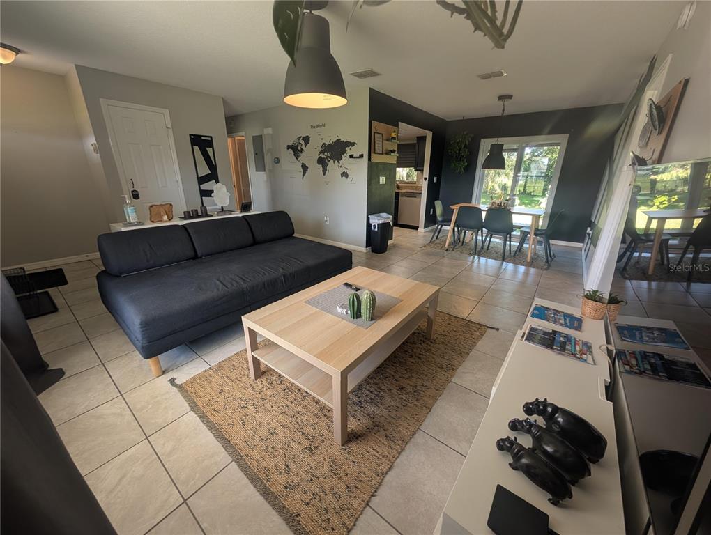 1675 Judith Drive, Unit A Kissimmee, FL 34758 - Photo 22 of 24 a living room with furniture and a table