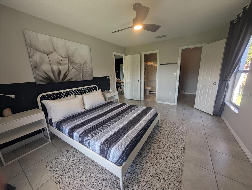 1675 Judith Drive, Unit A Kissimmee, FL 34758 - Photo 5 of 24 a bedroom with a bed and window