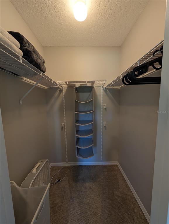 1675 Judith Drive, Unit A Kissimmee, FL 34758 - Photo 9 of 24 a view of walk in closet with clothes