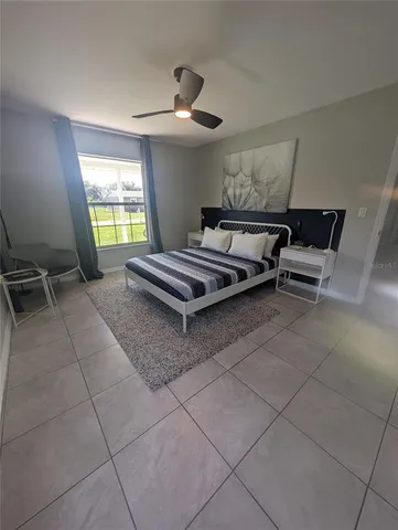 a living room with furniture a window and a chandelier
