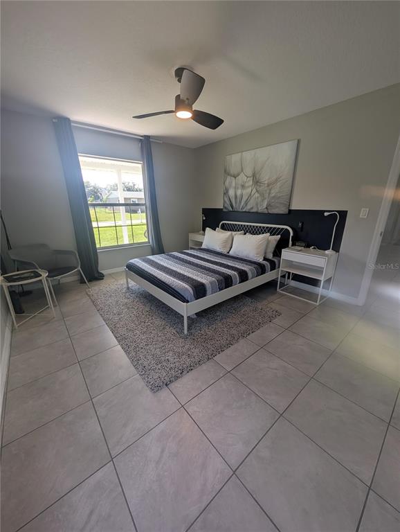 1675 Judith Drive, Unit A Kissimmee, FL 34758 - Photo 10 of 24 a living room with furniture a window and a chandelier