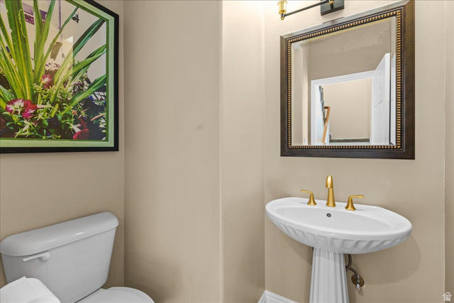 7824 South Sequoia Tree Lane Sandy, UT 84094 - Photo 18 of 43 Half bathroom featuring toilet and a sink