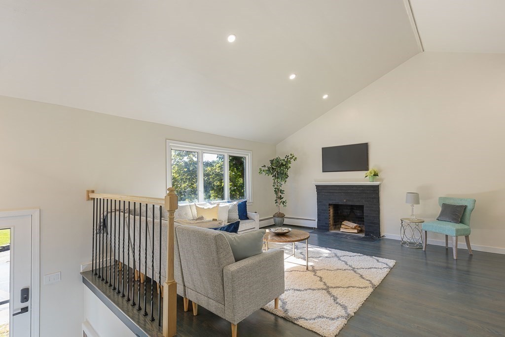 45 Revere Road Woburn, MA 01801 - Photo 17 of 32 a living room with furniture and a fireplace