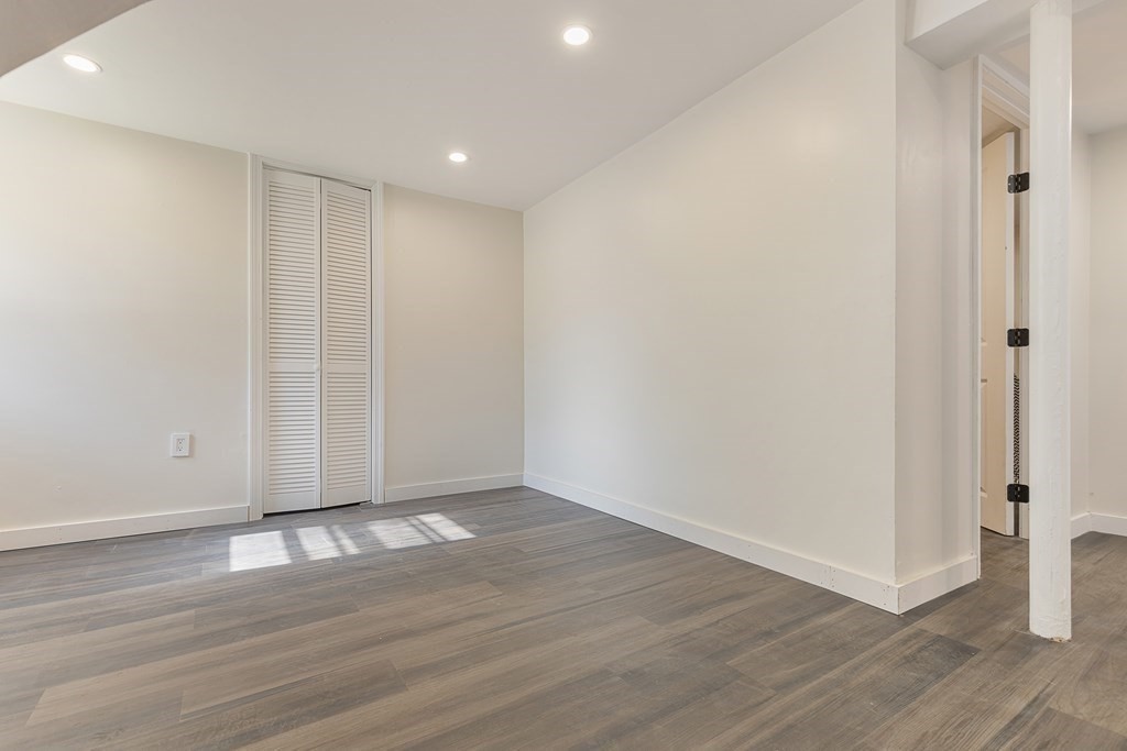 45 Revere Road Woburn, MA 01801 - Photo 18 of 32 a view of an empty room with wooden floor and a window