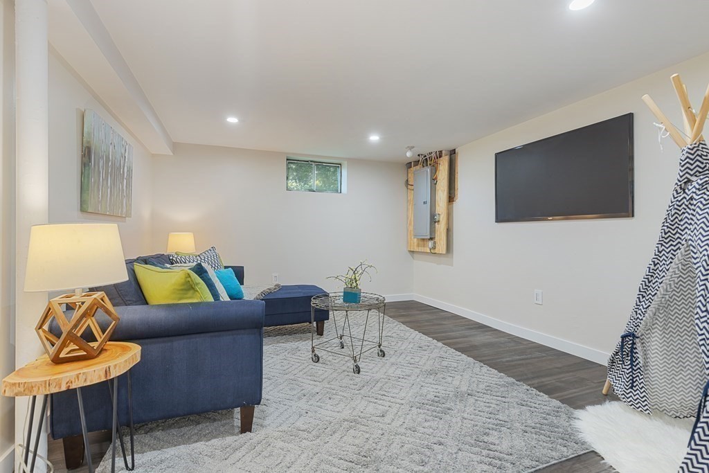 45 Revere Road Woburn, MA 01801 - Photo 19 of 32 a living room with furniture and a flat screen tv
