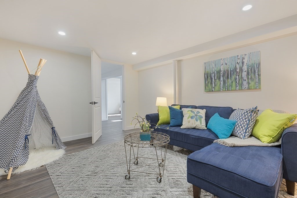 45 Revere Road Woburn, MA 01801 - Photo 20 of 32 a living room with furniture and a wooden floor