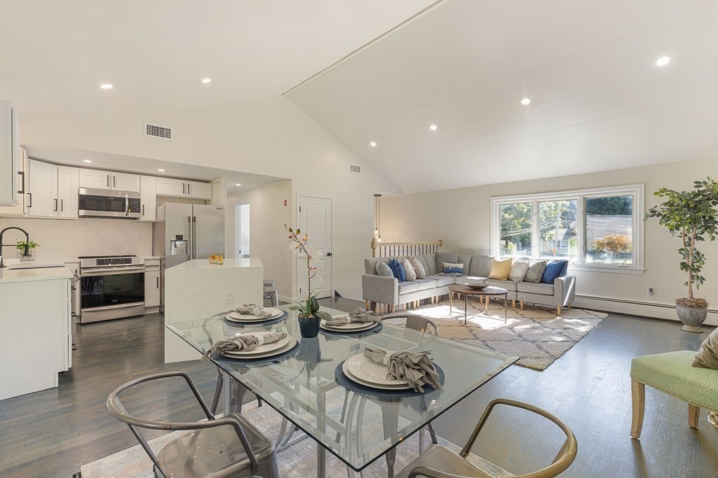 45 Revere Road Woburn, MA 01801 - Photo 2 of 32 a living room with lots of white furniture and kitchen view