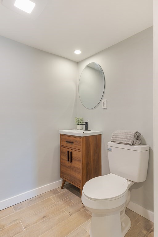 45 Revere Road Woburn, MA 01801 - Photo 25 of 32 a bathroom with a toilet a sink and mirror