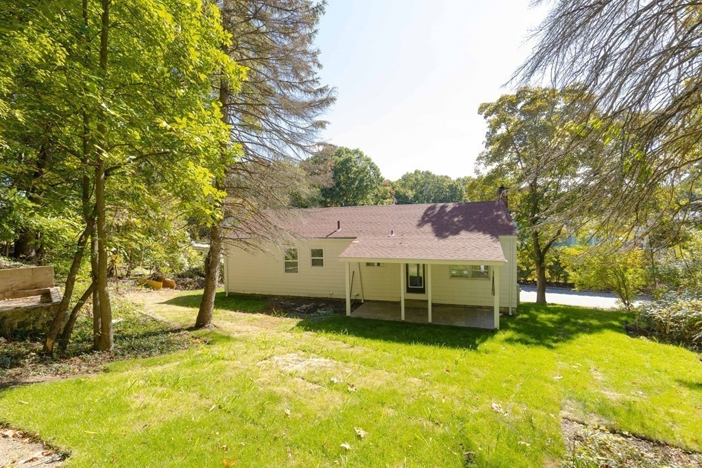 45 Revere Road Woburn, MA 01801 - Photo 30 of 32 a view of a house with a yard and tree