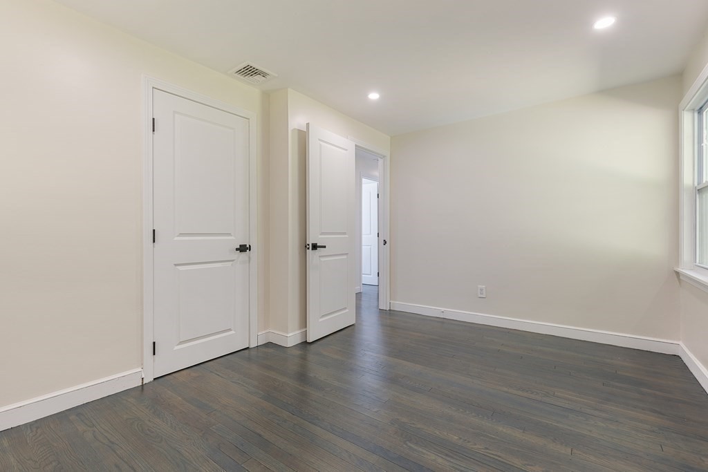 45 Revere Road Woburn, MA 01801 - Photo 7 of 32 a view of an empty room with wooden floor