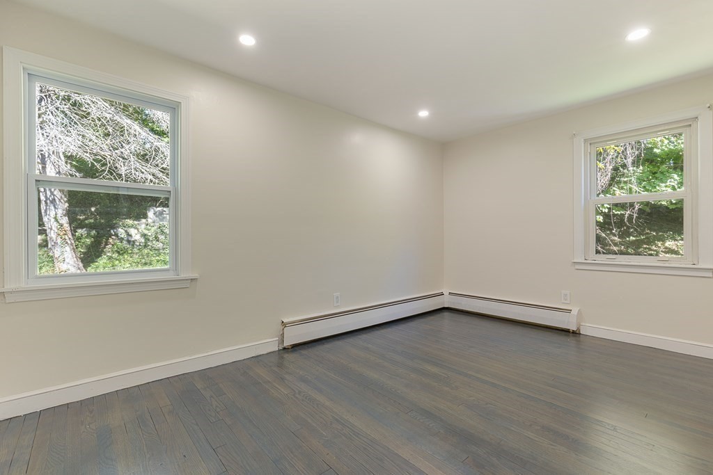 45 Revere Road Woburn, MA 01801 - Photo 8 of 32 an empty room with wooden floor and windows