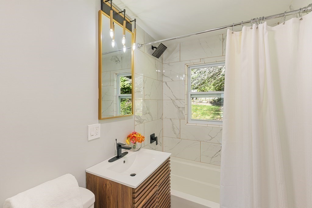 45 Revere Road Woburn, MA 01801 - Photo 10 of 32 a bathroom with a sink and a mirror