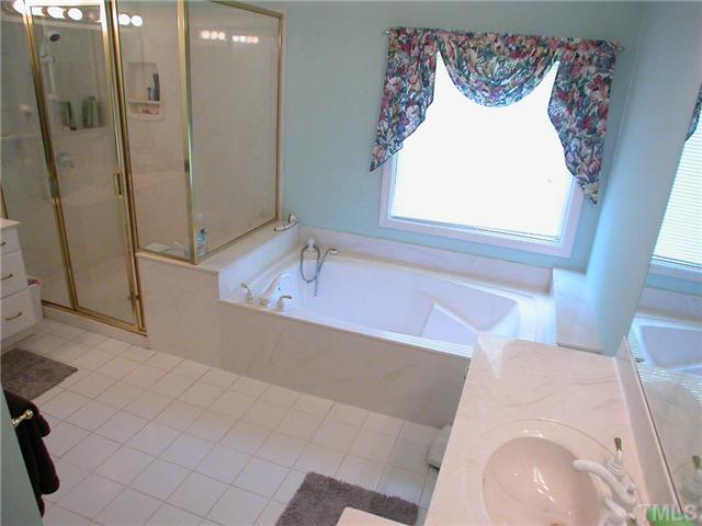 11708 Trottenham Street Raleigh, NC 27614 - Photo 18 of 22 Another view of the master bath showing one vanity to the right and just the corner of the second vanity to the left.