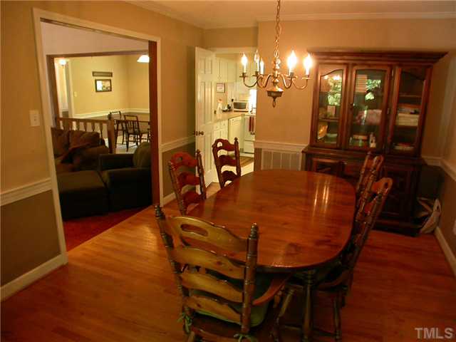 11708 Trottenham Street Raleigh, NC 27614 - Photo 8 of 22 Formal dining room with hardwood floors. Opens to the kitchen in rear and great room on the left. Opening to the sunroom at the back of the picture.