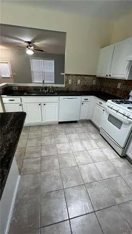 a kitchen that has a sink and a stove