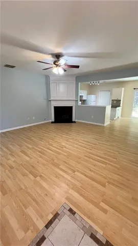 wooden floor in an empty room with a fireplace