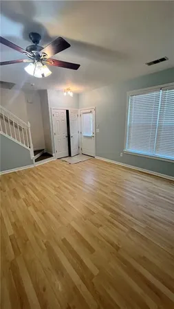 a view of empty room with wooden floor